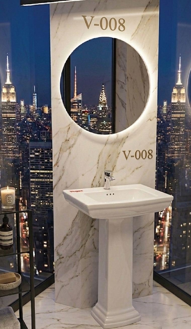 V-008 pedestal basin in a marble bathroom overlooking a city at night